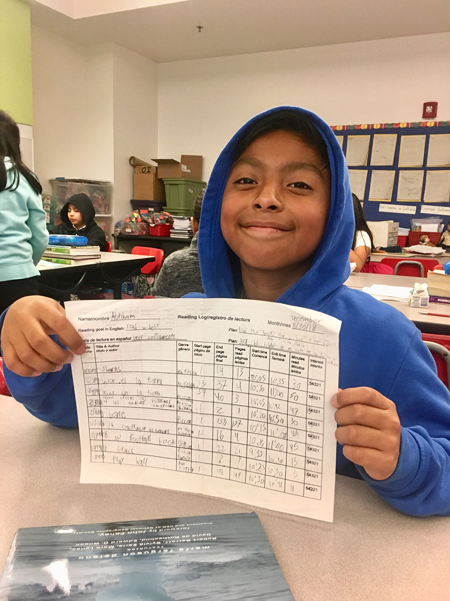student with reading log
