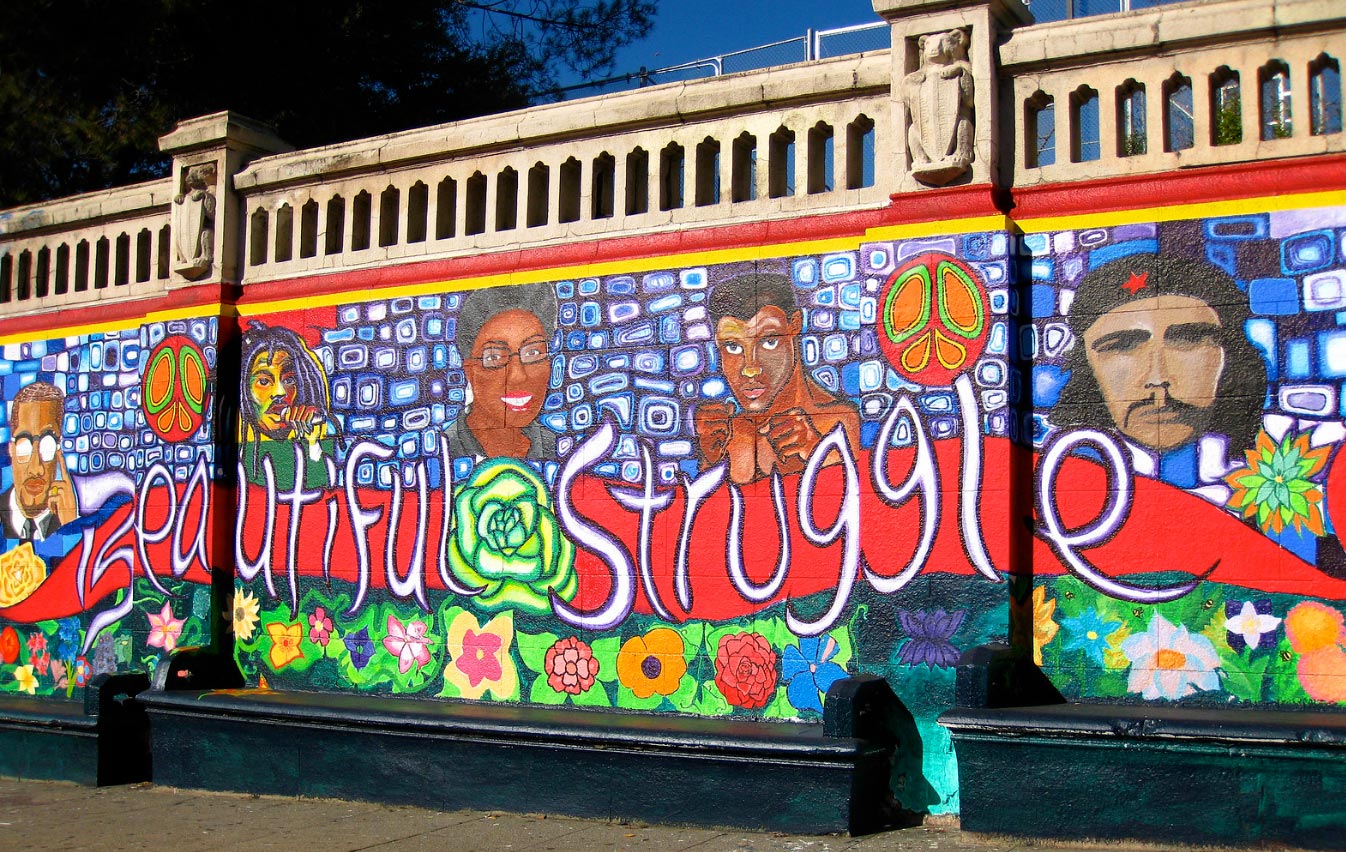 Mural of faces with the words Beautiful Struggle